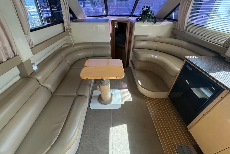 Slide: The Image of Interior of 2001 Bayliner 3488 Command Bridge Motoryacht with leather seating and wooden table. - 18