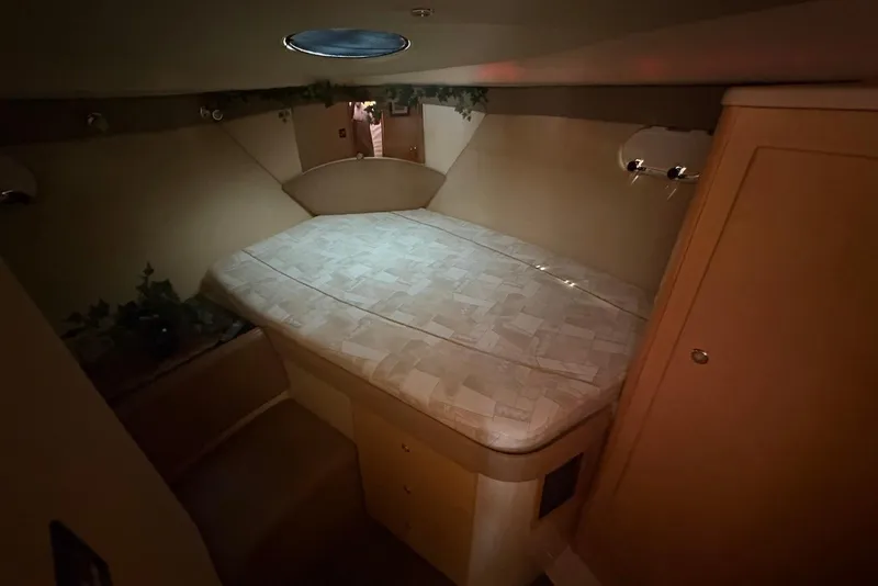 Slide: The Image of 2001 Bayliner 3488 Command Bridge Motoryacht cabin with cozy bed and ambient lighting. - 24