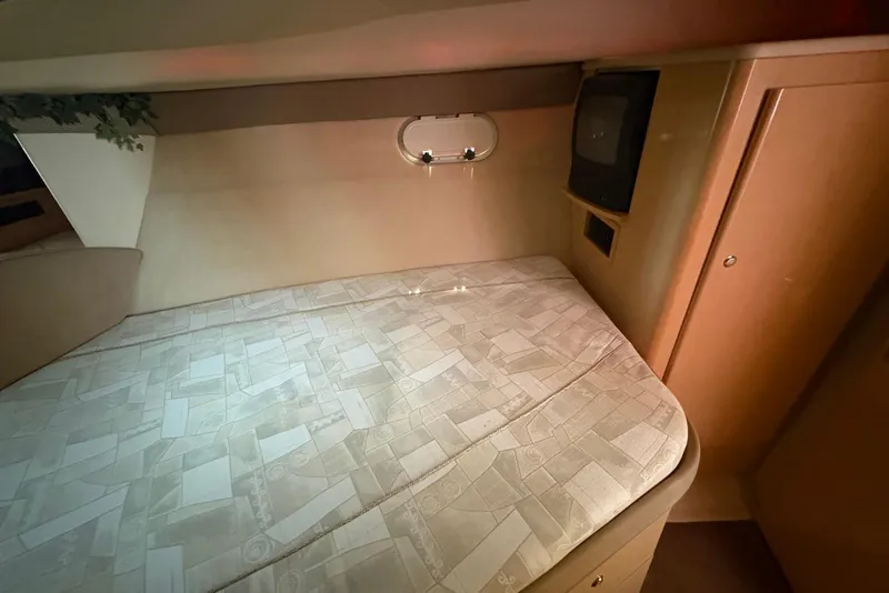 Slide: The Image of 2001 Bayliner 3488 Command Bridge Motoryacht cabin with bed and TV. - 26