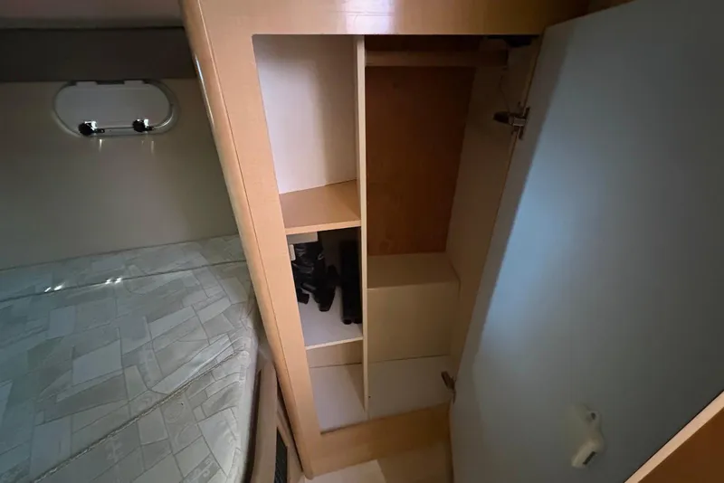 Slide: The Image of Interior of 2001 Bayliner 3488 Command Bridge Motoryacht showing cabin storage and bed. - 27