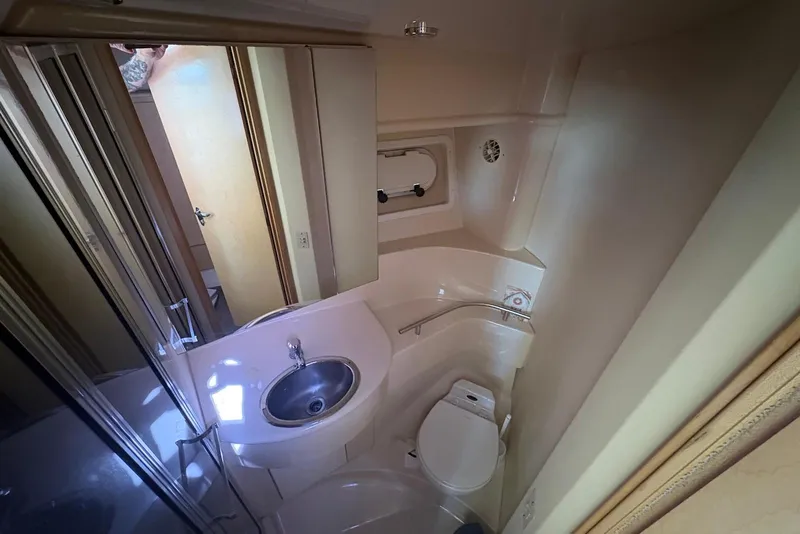 Slide: The Image of 2001 Bayliner 3488 Command Bridge Motoryacht bathroom with sink, toilet, and mirror. - 28