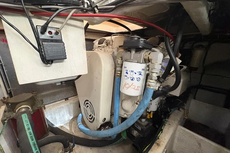 Slide: The Image of Engine compartment of a 2001 Bayliner 3488 Command Bridge Motoryacht, showing mechanical components and wiring. - 29