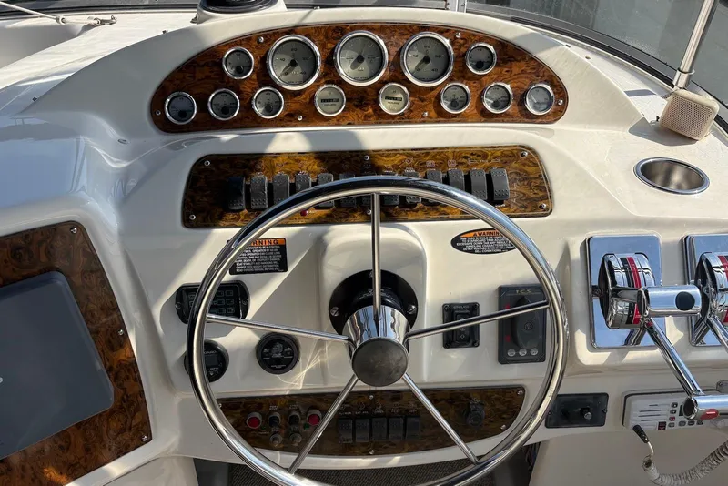 Slide: The Image of Dashboard of 2001 Bayliner 3488 Command Bridge Motoryacht with steering wheel and controls. - 5