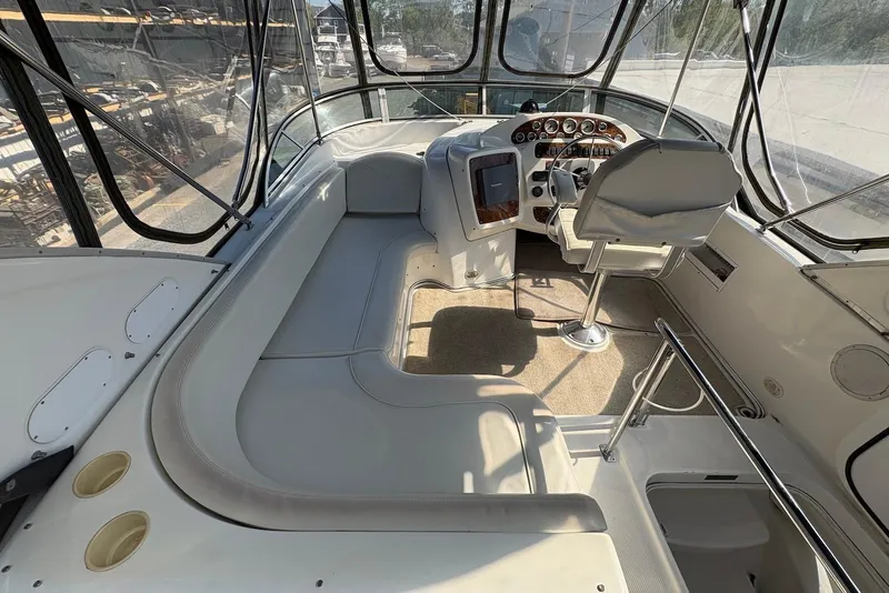 Slide: The Image of 2001 Bayliner 3488 Command Bridge Motoryacht cockpit with helm, seating, and panoramic windows. - 8