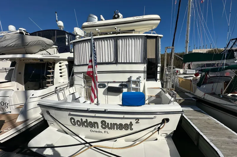 The Image of Novatec Islander 55 yacht, 2006 model, docked with American flag and "Golden Sunset" name. - 1