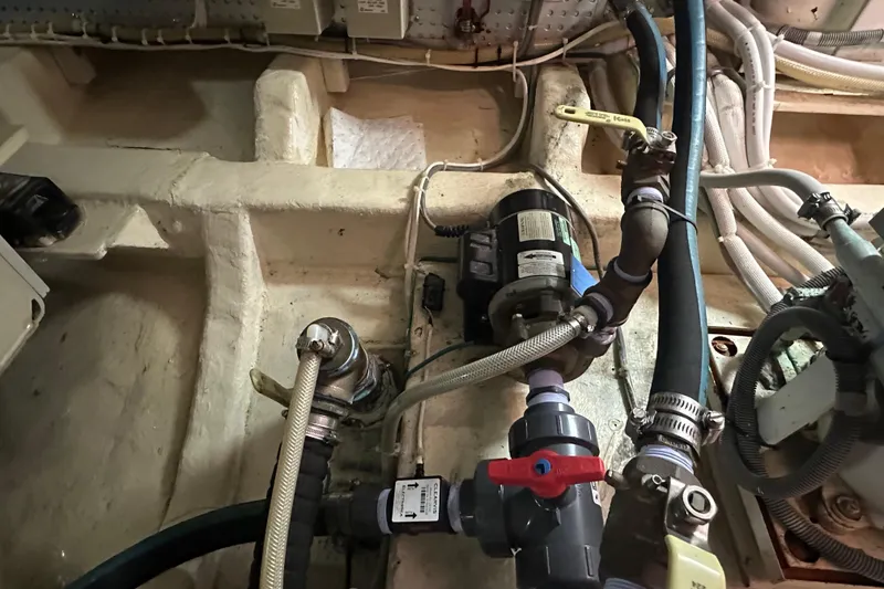 Slide: The Image of Engine room of 2006 Novatec Islander 55 with visible plumbing and wiring. - 101