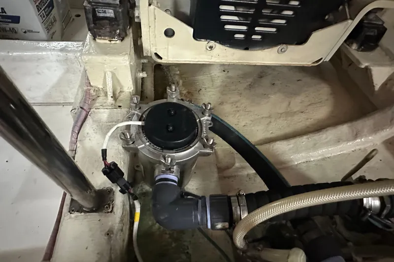 Slide: The Image of Engine compartment of 2006 Novatec Islander 55 yacht, featuring mechanical components and hoses. - 102