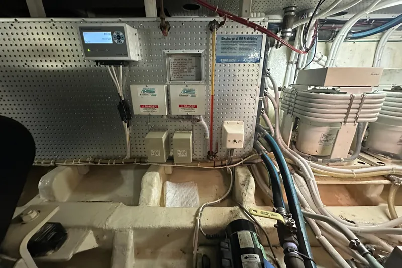 Slide: The Image of Engine room of 2006 Novatec Islander 55 yacht with control panels and wiring. - 104