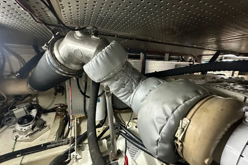 Slide: The Image of Engine room of 2006 Novatec Islander 55 yacht, featuring insulated exhaust system. - 113