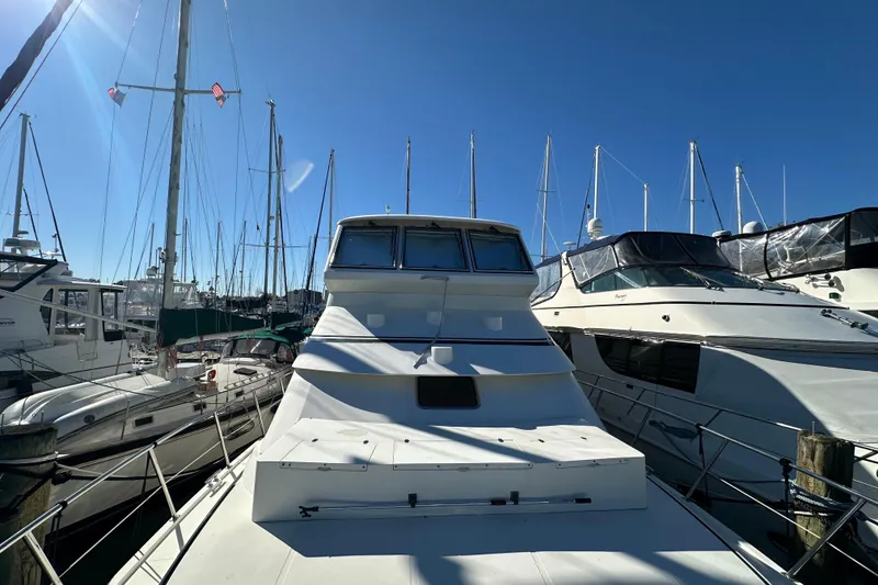 Slide: The Image of 2006 Novatec Islander 55 yacht docked among other boats under clear blue sky. - 13