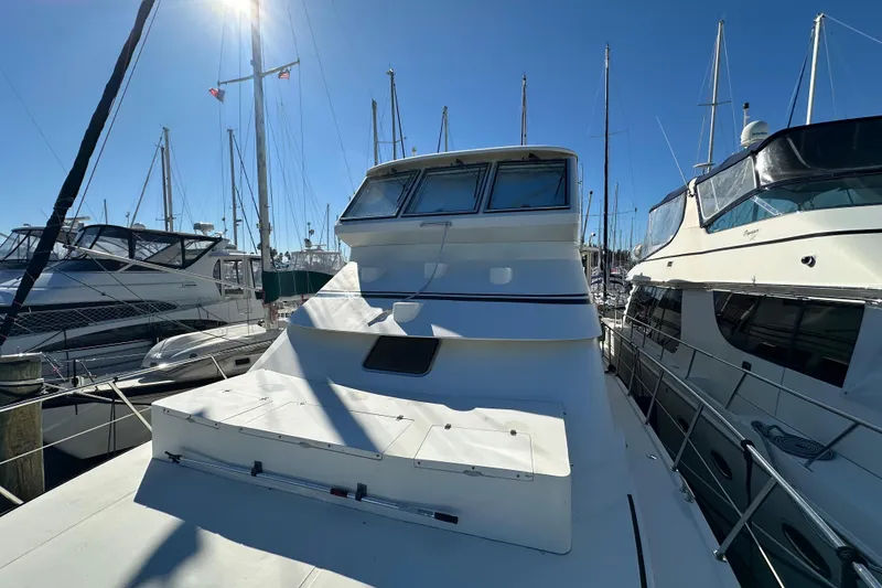 Slide: The Image of 2006 Novatec Islander 55 yacht docked in a sunny marina, surrounded by other boats. - 16