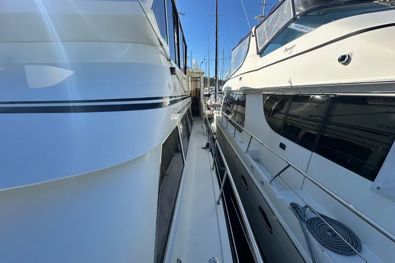 Slide: The Image of Two yachts docked side by side, featuring a 2006 Novatec Islander 55. - 17