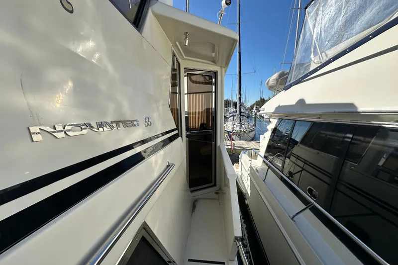 Slide: The Image of 2006 Novatec Islander 55 yacht docked, showcasing sleek exterior design and branding. - 20