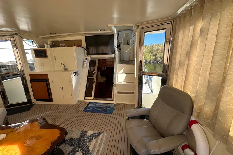 Slide: The Image of Interior of 2006 Novatec Islander 55 yacht with seating, kitchenette, and stairs. - 26