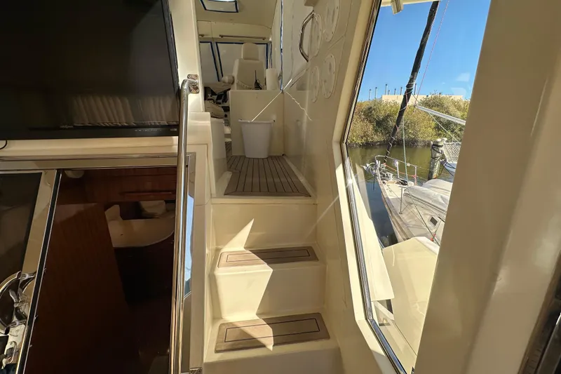 Slide: The Image of Stairway inside 2006 Novatec Islander 55 yacht, leading to upper deck with outdoor view. - 32