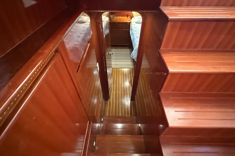 Slide: The Image of Luxurious wooden interior of 2006 Novatec Islander 55 yacht, featuring polished stairs and hallway. - 68