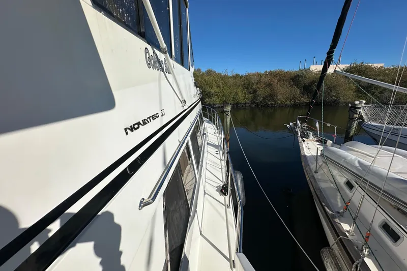 Slide: The Image of Novatec Islander 55 yacht, 2006 model, docked beside another boat on a sunny day. - 7