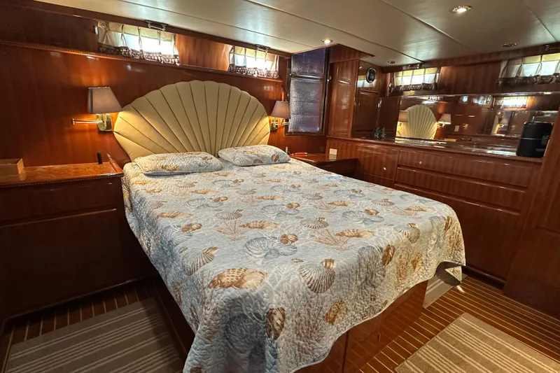 Slide: The Image of Luxurious bedroom in 2006 Novatec Islander 55 yacht with elegant wood paneling and seashell-themed bedding. - 71