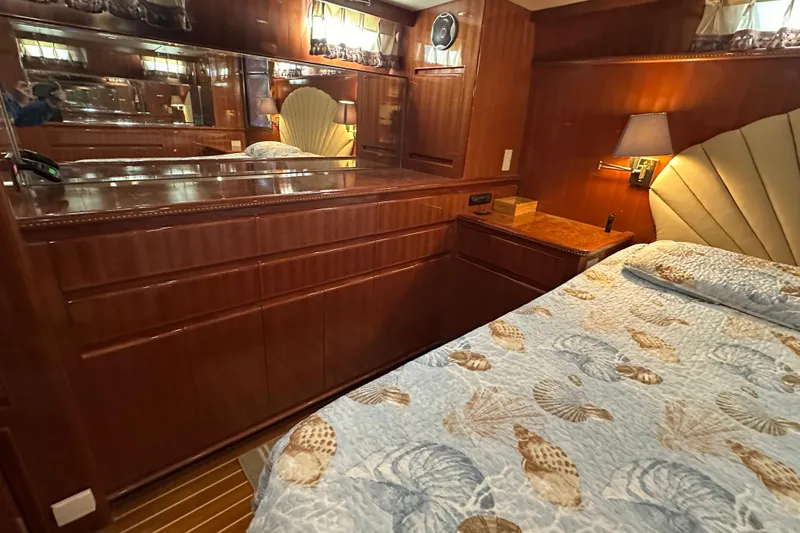 Slide: The Image of Luxurious 2006 Novatec Islander 55 yacht bedroom with elegant wood cabinetry and seashell-themed bedding. - 77