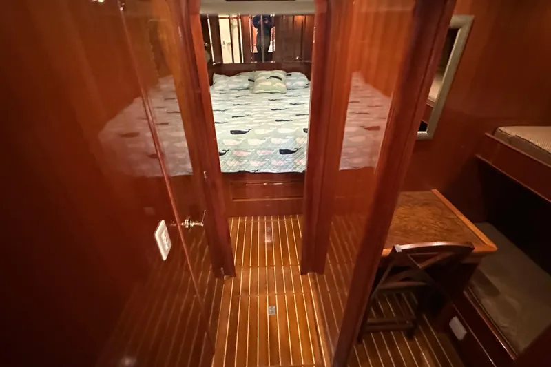 Slide: The Image of Luxurious wooden interior of 2006 Novatec Islander 55 yacht cabin with bed and desk. - 86