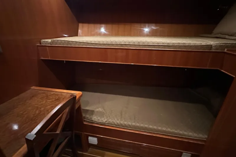 Slide: The Image of 2006 Novatec Islander 55 cabin with wooden bunk beds and a small desk. - 87