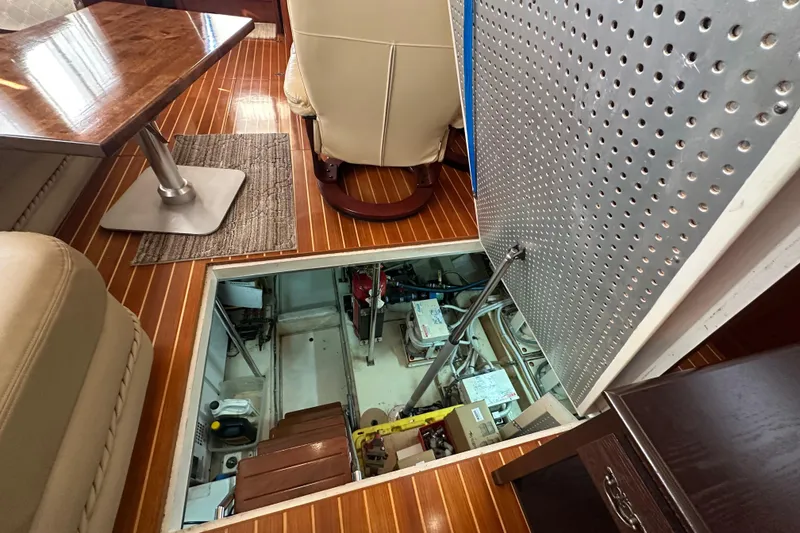Slide: The Image of Engine room access on 2006 Novatec Islander 55 yacht with wooden flooring and seating area. - 96