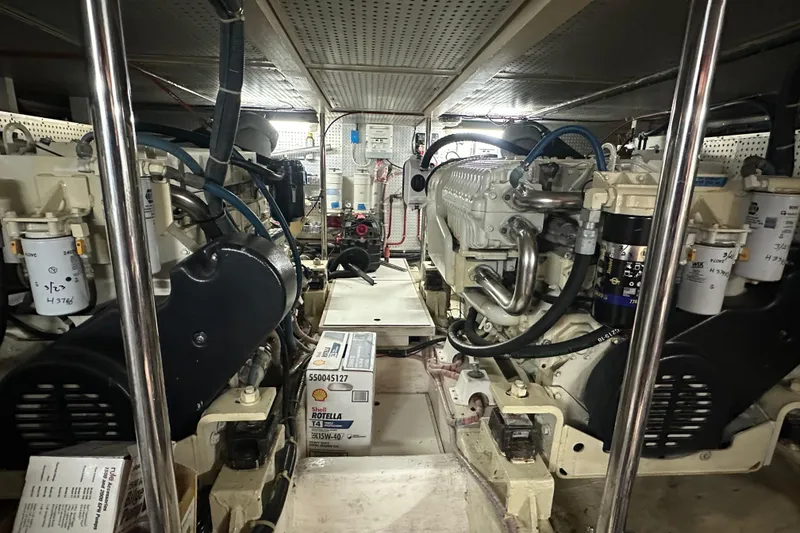 Slide: The Image of Engine room of 2006 Novatec Islander 55 yacht, featuring dual engines and maintenance supplies. - 97