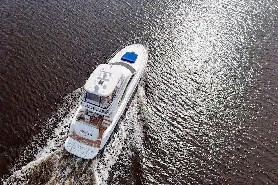 Slide: The Image of Aerial view of 2006 Sea Ray 580 Sedan Bridge yacht cruising on water. - 10