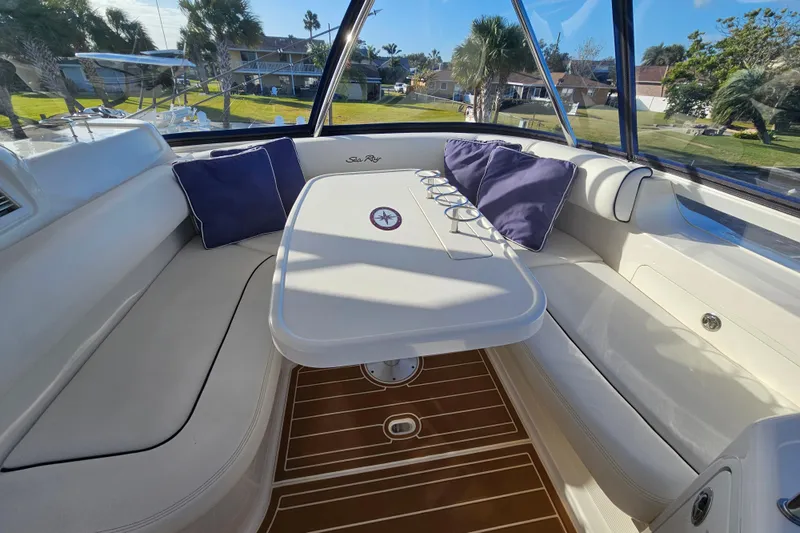 Slide: The Image of Luxurious interior of 2006 Sea Ray 580 Sedan Bridge with cushioned seating and table. - 16