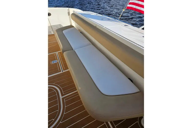 Slide: The Image of Luxury seating on 2006 Sea Ray 580 Sedan Bridge yacht, with American flag and teak deck. - 18
