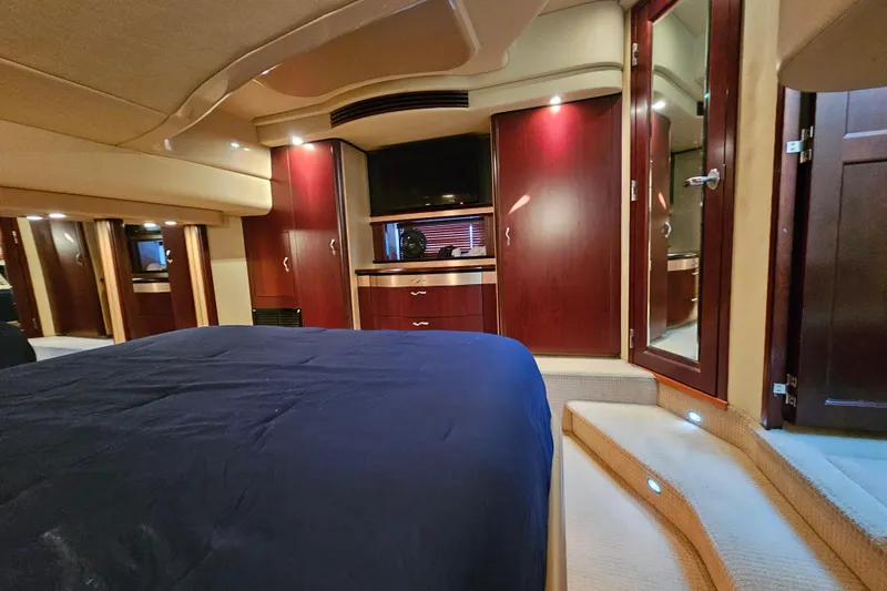 Slide: The Image of Luxurious interior of 2006 Sea Ray 580 Sedan Bridge yacht cabin with elegant wood finishes. - 27