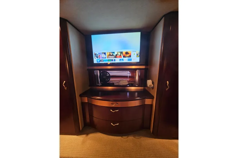 Slide: The Image of Luxurious interior of 2006 Sea Ray 580 Sedan Bridge with TV and wooden cabinetry. - 30
