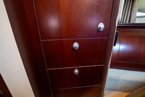 Slide: The Image of Wooden cabinet with drawers inside a 2006 Sea Ray 580 Sedan Bridge yacht. - 36