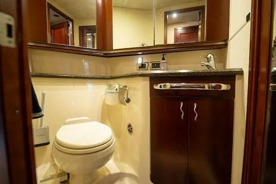 Slide: The Image of Luxurious bathroom in 2006 Sea Ray 580 Sedan Bridge yacht, featuring elegant wood cabinetry. - 37