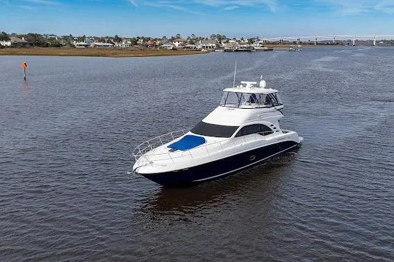 Slide: The Image of 2006 Sea Ray 580 Sedan Bridge yacht cruising on a calm river. - 4