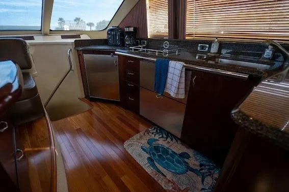 Slide: The Image of Luxurious 2006 Sea Ray 580 Sedan Bridge yacht kitchen with wood flooring and modern appliances. - 41
