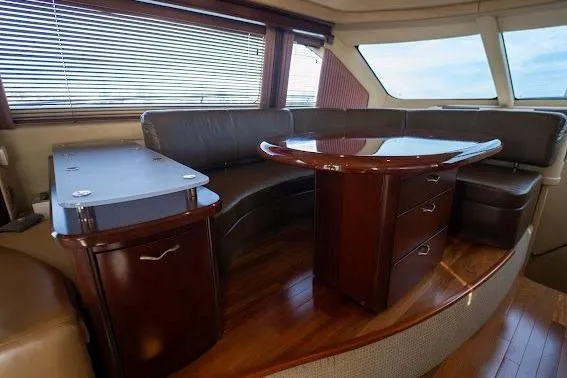 Slide: The Image of Luxurious interior of 2006 Sea Ray 580 Sedan Bridge with elegant wood finishes and leather seating. - 42