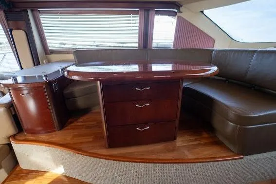 Slide: The Image of Luxurious interior of 2006 Sea Ray 580 Sedan Bridge with elegant wood furnishings. - 44