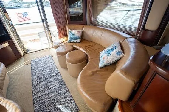 Slide: The Image of Luxurious interior of 2006 Sea Ray 580 Sedan Bridge yacht with leather seating and decorative pillows. - 45