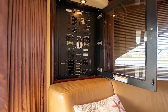 Slide: The Image of Electrical panel inside 2006 Sea Ray 580 Sedan Bridge yacht, with beige seating and decorative pillow. - 47