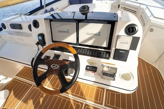 Slide: The Image of Helm of 2006 Sea Ray 580 Sedan Bridge with Garmin navigation displays and wood-accented steering wheel. - 52