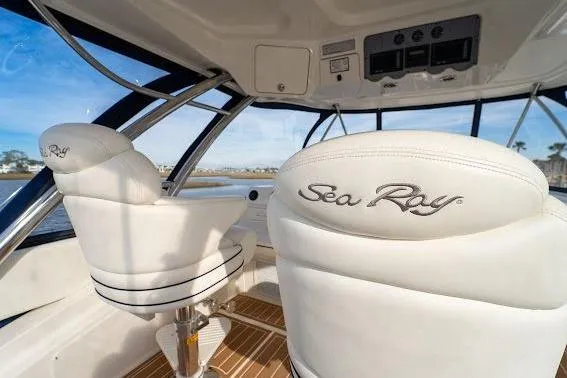 Slide: The Image of 2006 Sea Ray 580 Sedan Bridge interior with white leather seats and panoramic windows. - 54