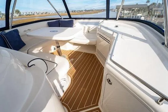 Slide: The Image of 2006 Sea Ray 580 Sedan Bridge interior with elegant seating and wooden flooring. - 56