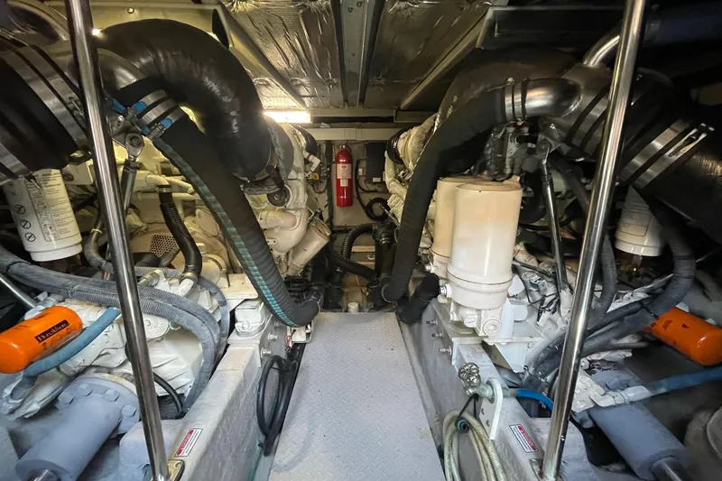 Slide: The Image of Engine room of a 2006 Sea Ray 580 Sedan Bridge yacht, showcasing mechanical components. - 59