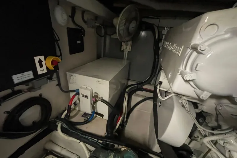 Slide: The Image of Engine room of 2006 Sea Ray 580 Sedan Bridge with visible machinery and wiring. - 61