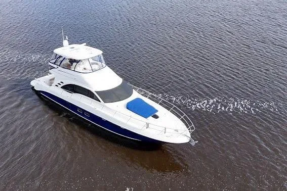 Slide: The Image of 2006 Sea Ray 580 Sedan Bridge yacht cruising on open water. - 62