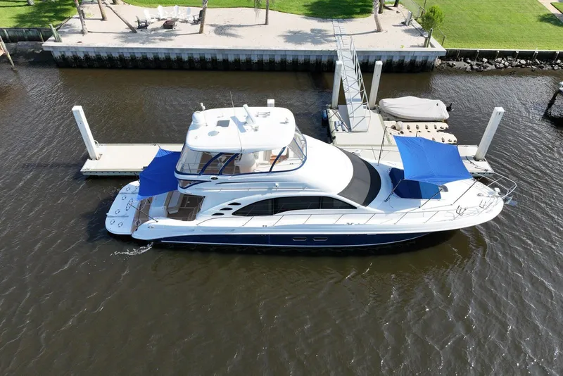 Slide: The Image of 2006 Sea Ray 580 Sedan Bridge yacht docked at marina with blue sunshades. - 7
