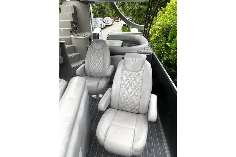 Slide: The Image of Luxurious seating area on 2022 Premier Escalante boat with table and cup holders. - 13