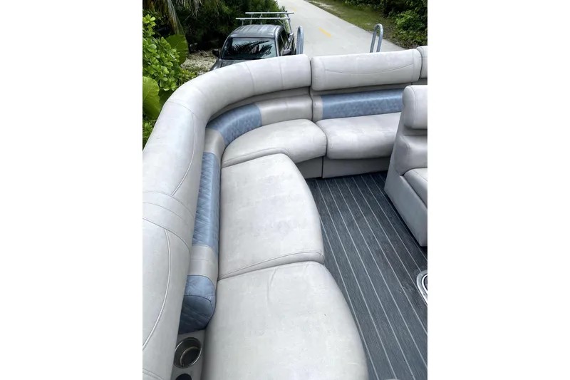 Slide: The Image of Luxurious seating on 2022 Premier Escalante boat with Suzuki engines in background. - 15