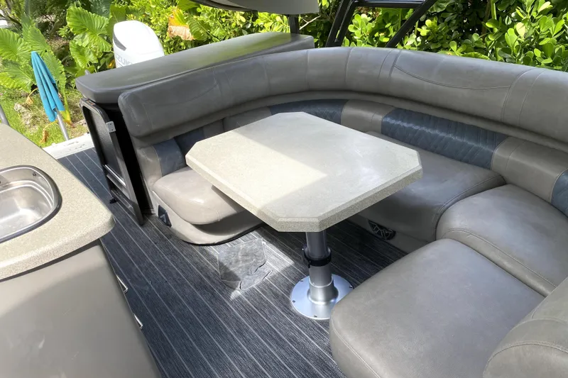 Slide: The Image of Premier Escalante 2022 boat interior with blue and gray cushioned seating. - 16